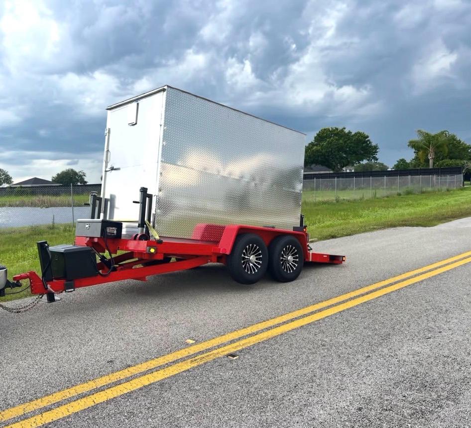 SPS portable storage container on a red delivery trailer